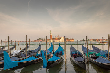 Iconic Venice gondolas and a warm sunset