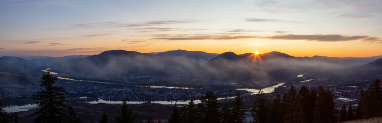 Beautiful Panoramic View of a Canadian City, Kamloops, during a colorful summer sunrise. Located in the Interior British Columbia, Canada.