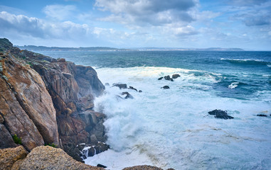 Fototapeta na wymiar Galician seascape in Coitelada, Ares, La Coruña, Spain. Sea with a lot of waves breaking on the rocks