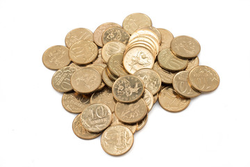 A close up pile, shot in macro, of a pile of Russian ten kopeyka coins on a clean, white background