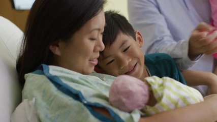 Close up of family admiring newborn baby