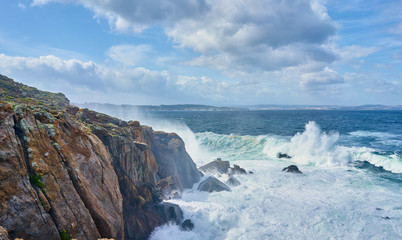 Galician seascape in Coitelada, Ares, La Coruña, Spain. Sea with a lot of waves breaking on the rocks
