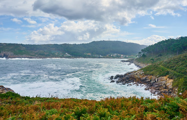 Fototapeta na wymiar Galician seascape in Coitelada, Ares, La Coruña, Spain. Sea with a lot of waves breaking on the rocks
