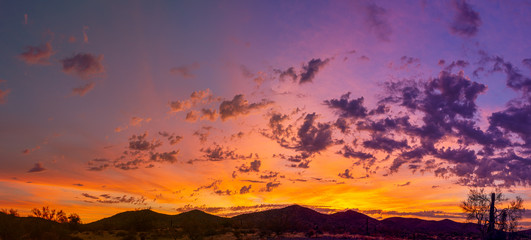 Naklejka premium Sunrise panorama over the sonoran desert of Arizona with layers of mountains shot at altitude by a drone.