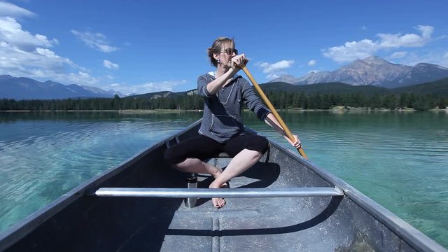Caucasian woman paddling in canoe, Jasper, Alberta, Canada