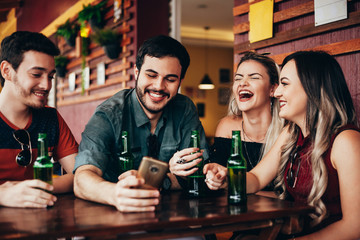 Group of friends having a good time at the bar