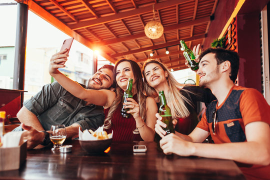 Group of friends having a good time at the bar