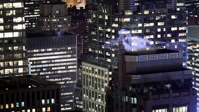 Steam from roof of building in Manhattan at night, New York, United States
