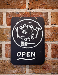 Repair cafe sign on chalk board on cafe wall illustration, right to repair concept to reduce waste