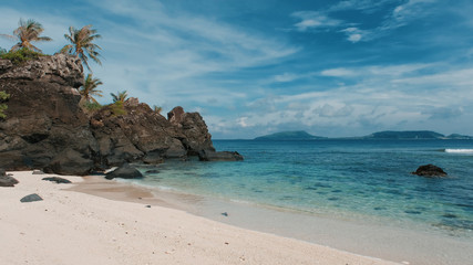 Deserted island, uninhabited island. Royalty high-quality stock photo image of desert island with palm tree, coconut trees on the beach, tropical beach clear turquoise water. Quiet, peaceful landscape