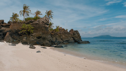 Deserted island, uninhabited island. Royalty high-quality stock photo image of desert island with palm tree, coconut trees on the beach, tropical beach clear turquoise water. Quiet, peaceful landscape
