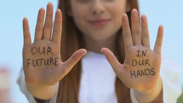 Our future in our hands written on female palms, goal achievement challenge