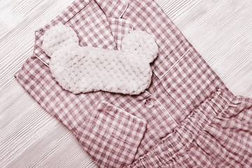 Soft red cotton pajamas with checkered pattern. Warm shirt and pants. Comfortable wear for home and sleeping. Top view. Flat lay.