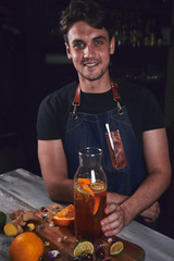 Young chef in kitchen preparing juice. Food concept.