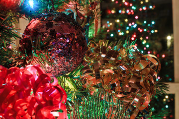 Colorful Christmas ornaments on a tree make a colorful holiday background.