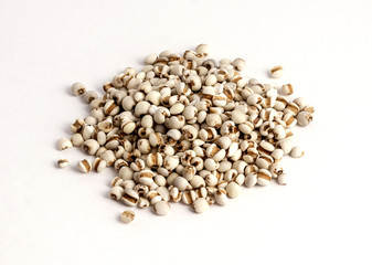 dried pearl barley on white background..