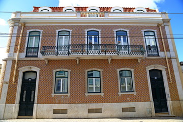 Traditional colorful buildings with azulejo tiles facade in the old Lisbon neighborhoods Portugal