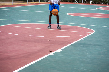 Young boy practicing his free throws on court