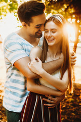 Romantic young couple embracing outdoor in the park. Happy couple dating while traveling in their vacation time. Red hair female with freckles with man.