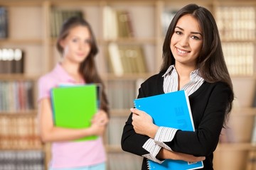 Young smiling woman holding blue notebook