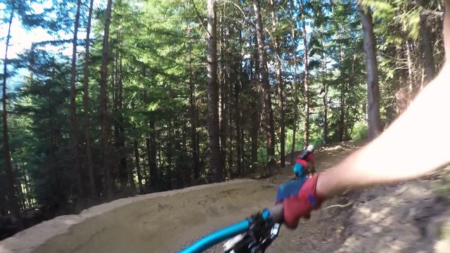 Two Males Mountain Biking Fast Through Forest 