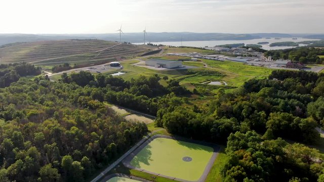Reverse aerial of landfill, cesspool and sludge in retention basin, renewable energy and waste management theme