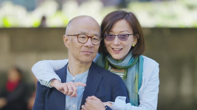 Portrait of middle aged Asian couple smiling to camera