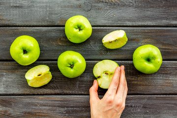Autumn composition with green apple on dark wooden background top view