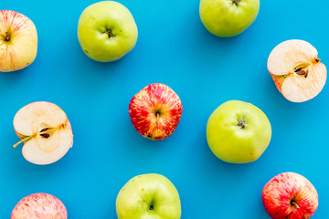 Autumn composition with fresh apples on blue background top view pattern