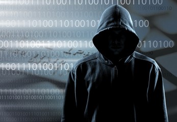 Thief in black clothes on grey background