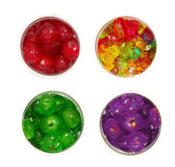 gummy ,green dry sweet cherry and red sugar cherry in jars on isolated white background