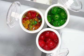 gummy ,green dry sweet cherry syrup and red sugar cherry in jars.jpg