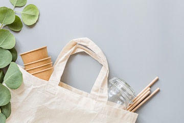 eco natural paper cups, straws, toothbrush flat lay on gray background. sustainable lifestyle concept. zero waste, plastic free items. stop plastic pollution. Top view, overhead, template, Mockup.