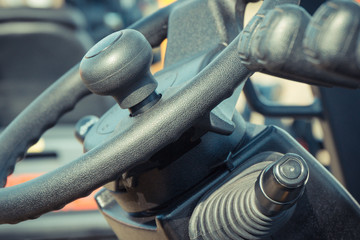 Steering wheel and operating control levers in loader machine