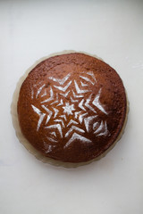 Powdered sugar pattern on pastries in the center of the background. Confectionery on a white background. View from above.
