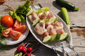raw kebab on skeawers with vegetables. Picnic
