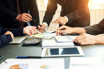 Business group or business partners discussing documents and ideas at meeting