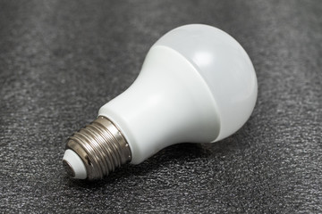 White LED light bulb on a black background. Incandescent lamp. Lighting device.