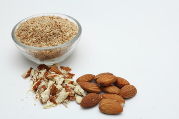Raw whole, crushed and ground almonds on white background.