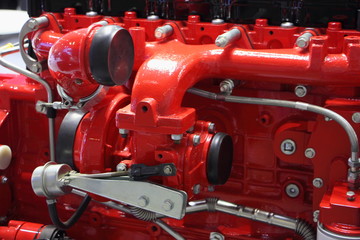Fototapeta premium Close up fragment of new red truck engine, turbine on intake manifold of powerful turbo motor