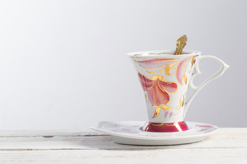 beautiful porcelain cup on white wooden table