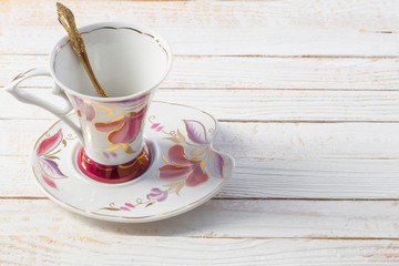 beautiful porcelain cup on white wooden table
