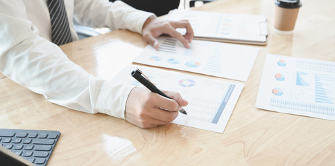 Cropped shot of young accountant preparing and reviewing budgets document