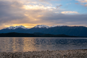 Sunset over the snow capped souther alps by the lake