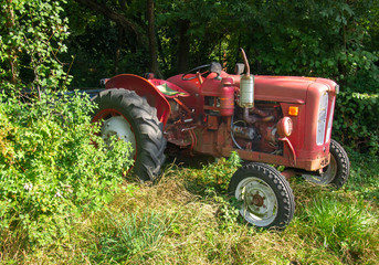 red vintage tractor of the 20th century