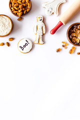 spooky halloween figures with rolling pin, flour, sugar, almond for cooking treat on white background top view mock up