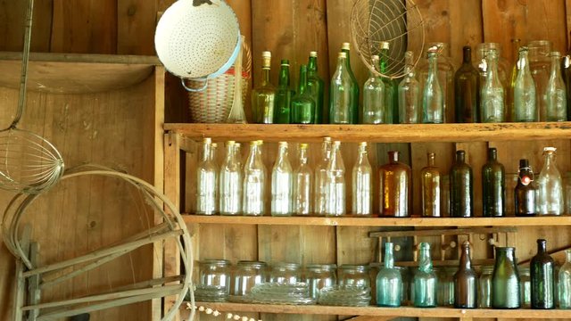 Jar bottles with glass and carboy, traditional Moravia cottage old folk Hana. Interior of peasant and dishes glassful hut, farmhouse, house articles furniture crockery or tumblerful punch things