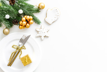 Table setting with spruce, plate, flatware on white background top view mockup