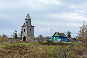 Fototapeta premium Tetyushi, Tatarstan - May 2, 2019. A wooden observation tower on a high mountain on the coast of the Volga River. The tower is a copy of the tower built during the founding of the town Tetyushi.