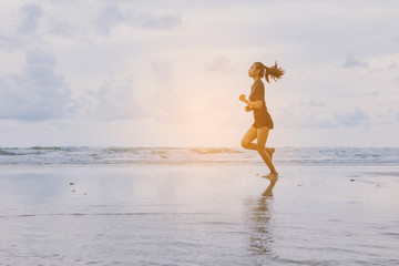 Runners. Young people running on beach. Athletic attractive people jogging on beach enjoying the sun exercising their healthy lifestyle.